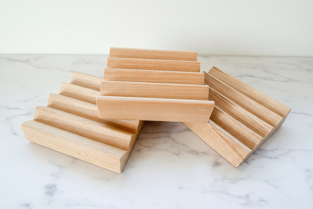 3 wooden soap dishes on a white surface