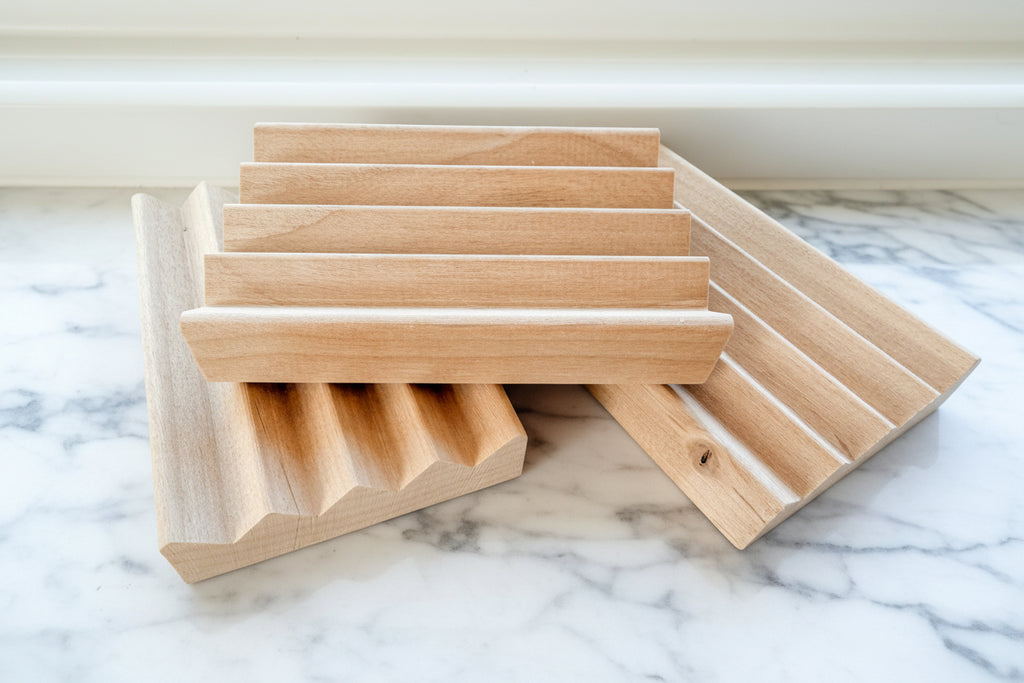 3 alderwood draining soap dish on a white surface