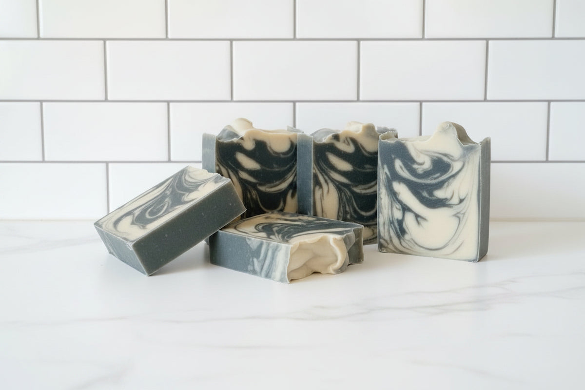 5 bar soaps with black and white swirls on a white surface