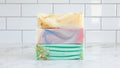 three soaps with multi colors on a white background