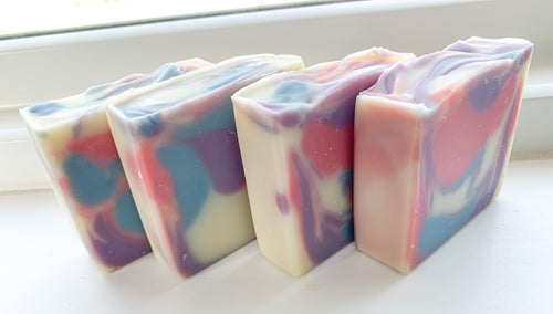 Square bar soap with pink, purple and blue swirls in a white base