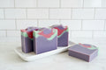 brightly colored swirled bar with pinks & purples on a white counter with white background