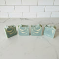 four bar soap with blue and white swirl on a white surface