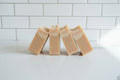 four peach colored bar soaps on a white surface