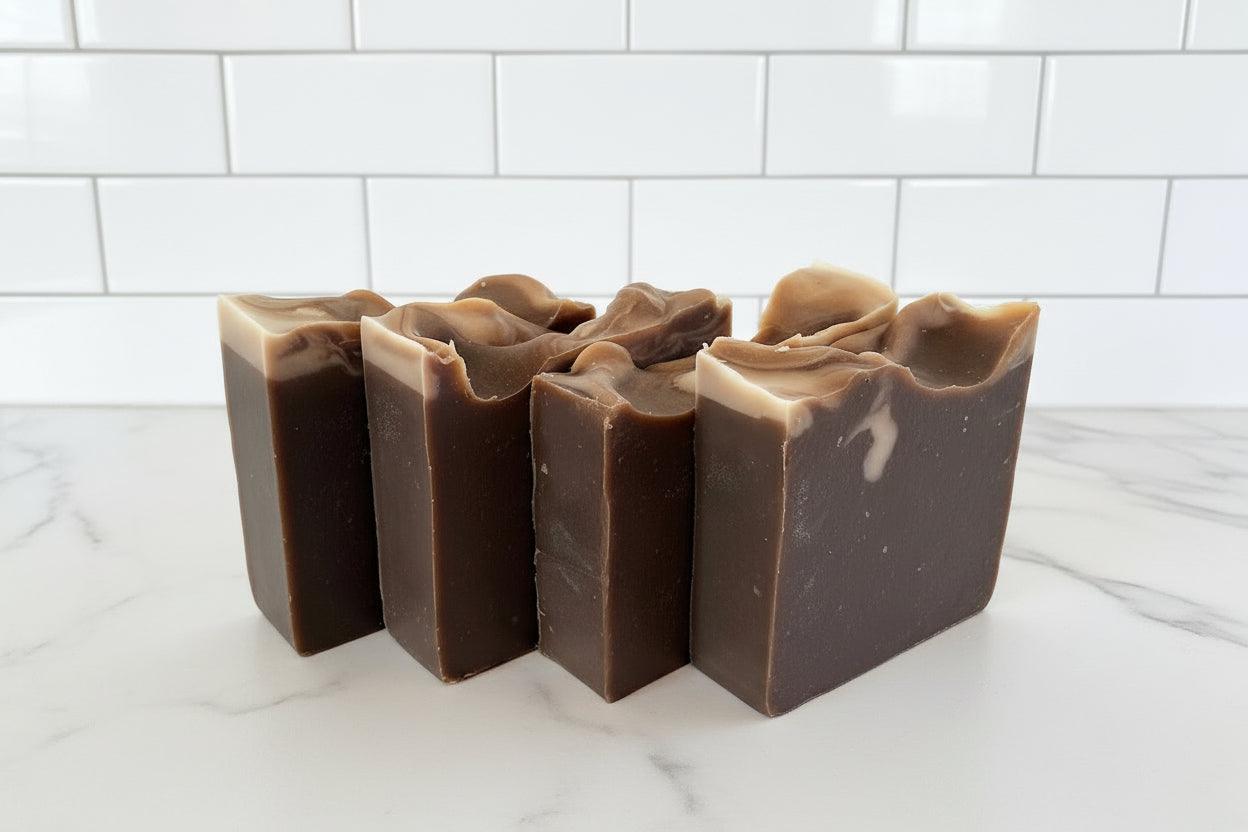 Vegan bar soap with vanilla bean scent profile and dark brown in color on a white surface