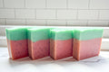 four bar soap with pink and green to mimmick a watermelon with poppyseeds for exfoliation